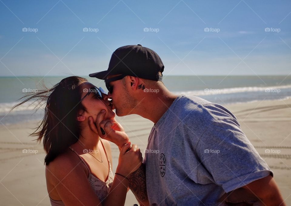 Couple kissing on lips at the beach