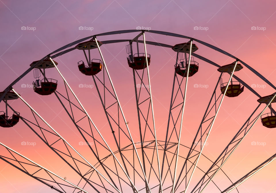 Silhouette of the ferris wheel at the sunset