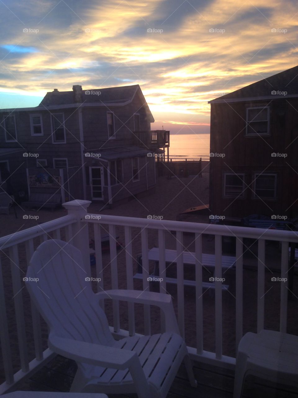 A peaceful view of a brilliant sunrise over the Salisbury Beach, MA coastline from a beach house.
