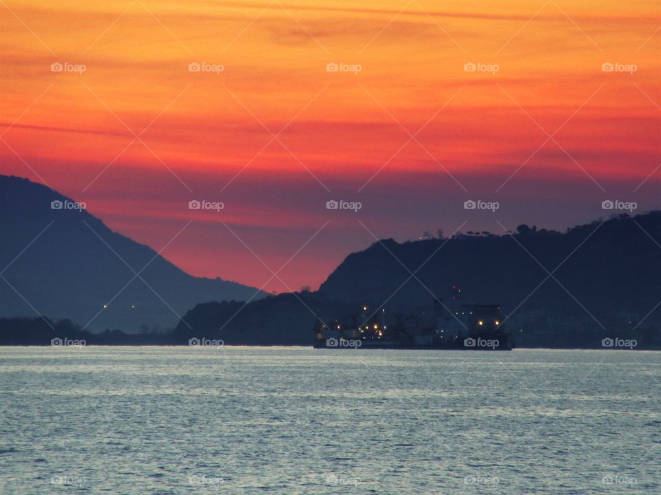 Sunset over Bacoli and Island of Ischia seen from Bagnoli ( Naples - Italy ).