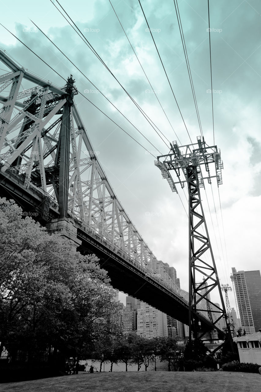 by air or by land. Tram structure next to a bridge. Roosevelt Island, New York City