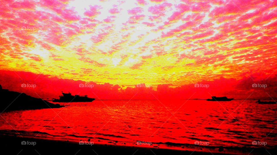 The sun rises on the coast of sanur