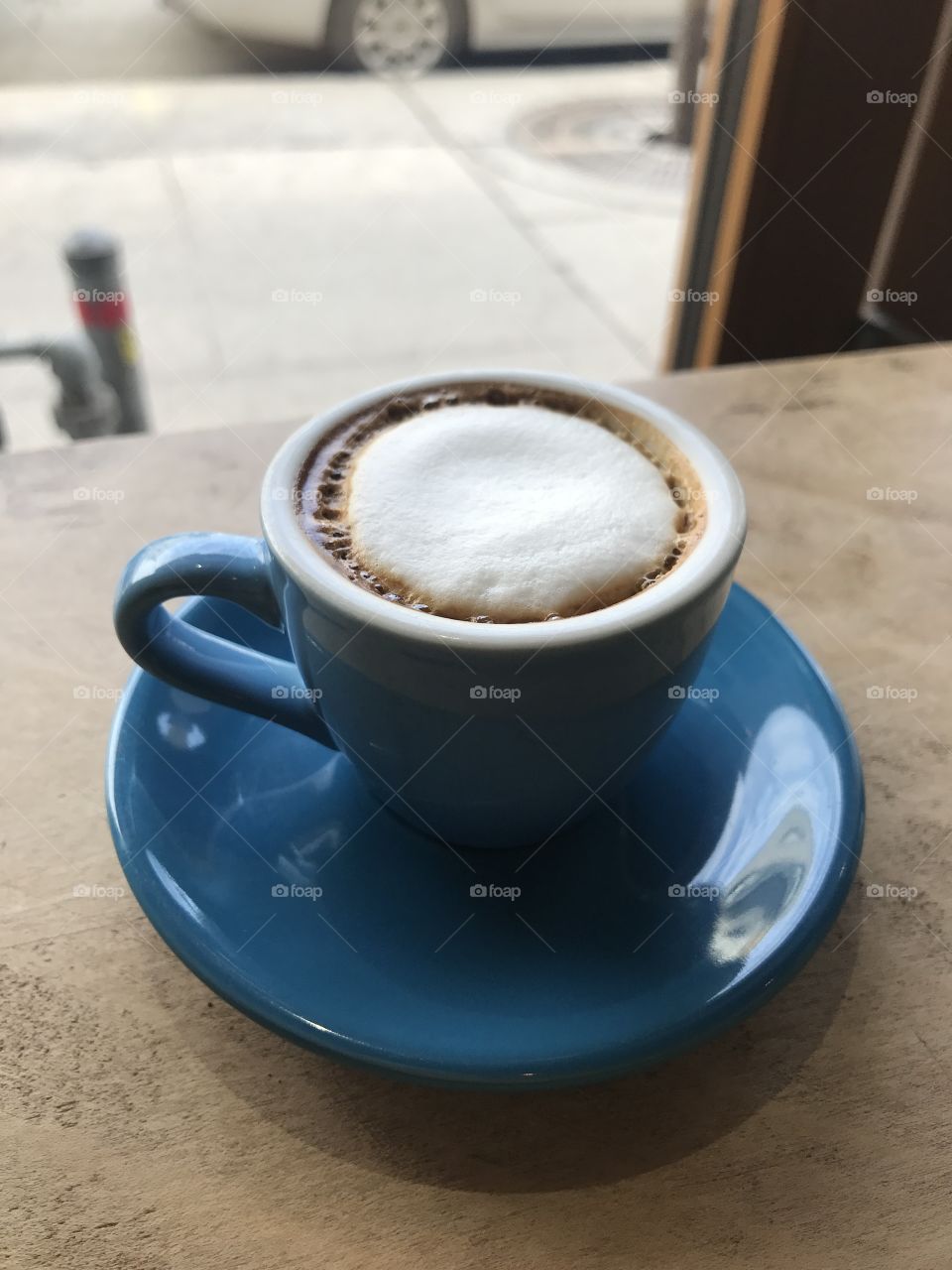 Artisanal cappuccino in blue ceramic mug