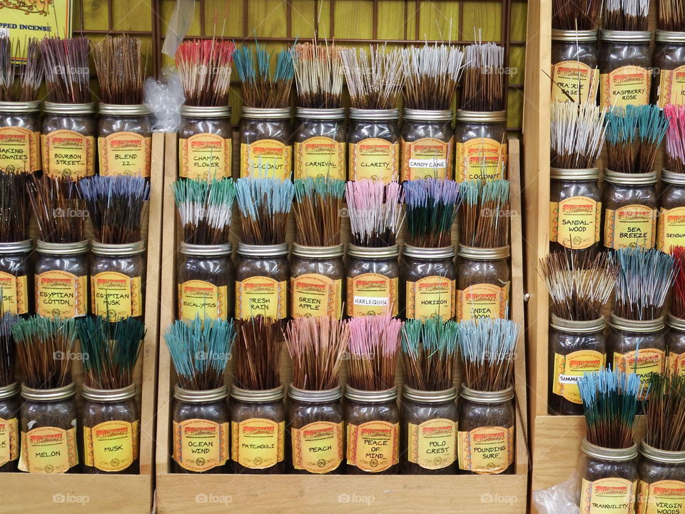 Variety of colored incense in jars.