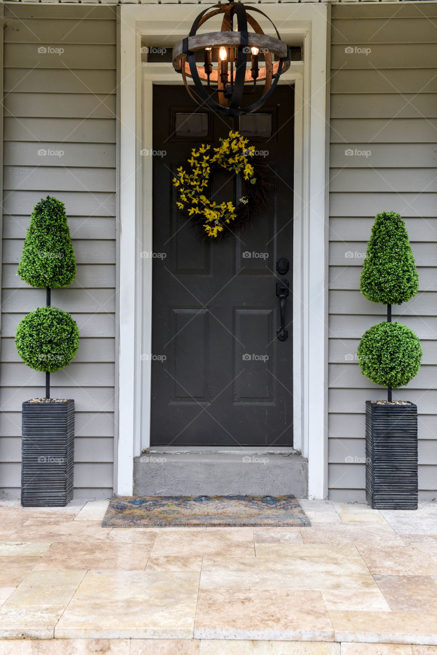 Front door of a house with rectangular planters on either side