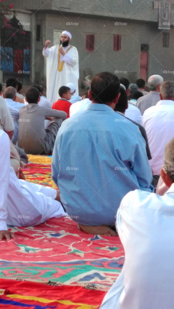 The worshipers listen to the Eid prayer sermon