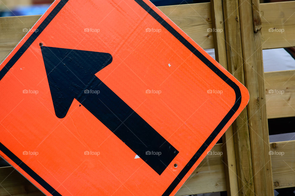 Orange arrow on wood pointing up 