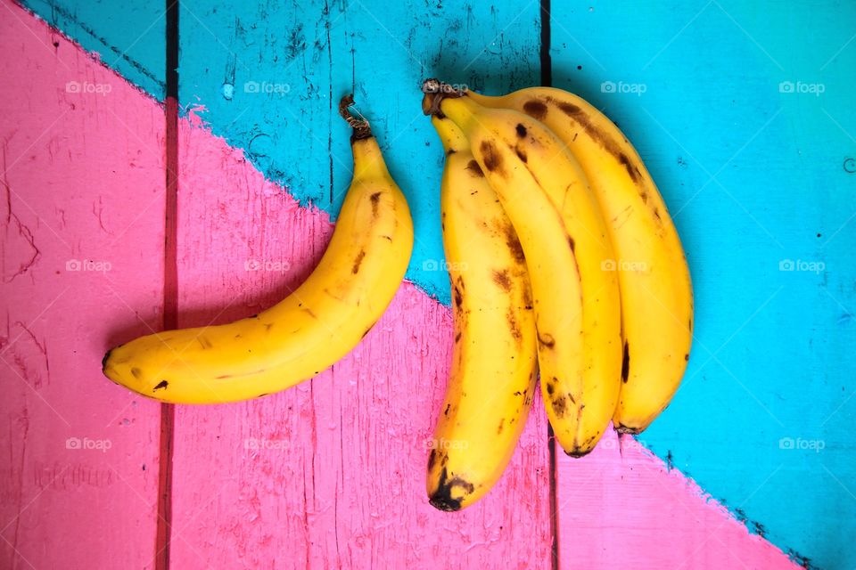Bananas on a colourful wooden table