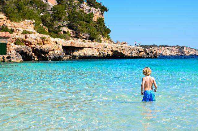Boy swimming in Cala Lombards