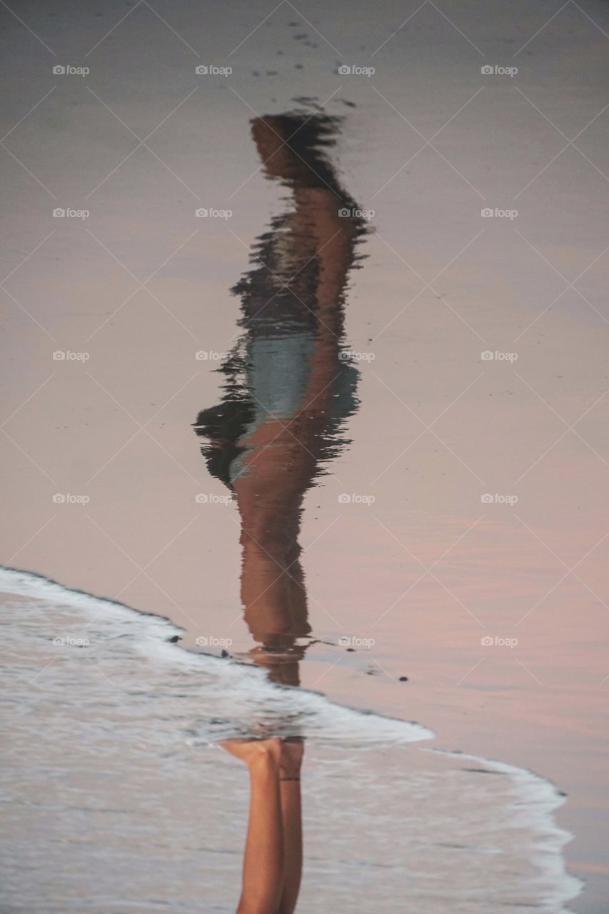 Reflection freezed in the wet sand on the beach