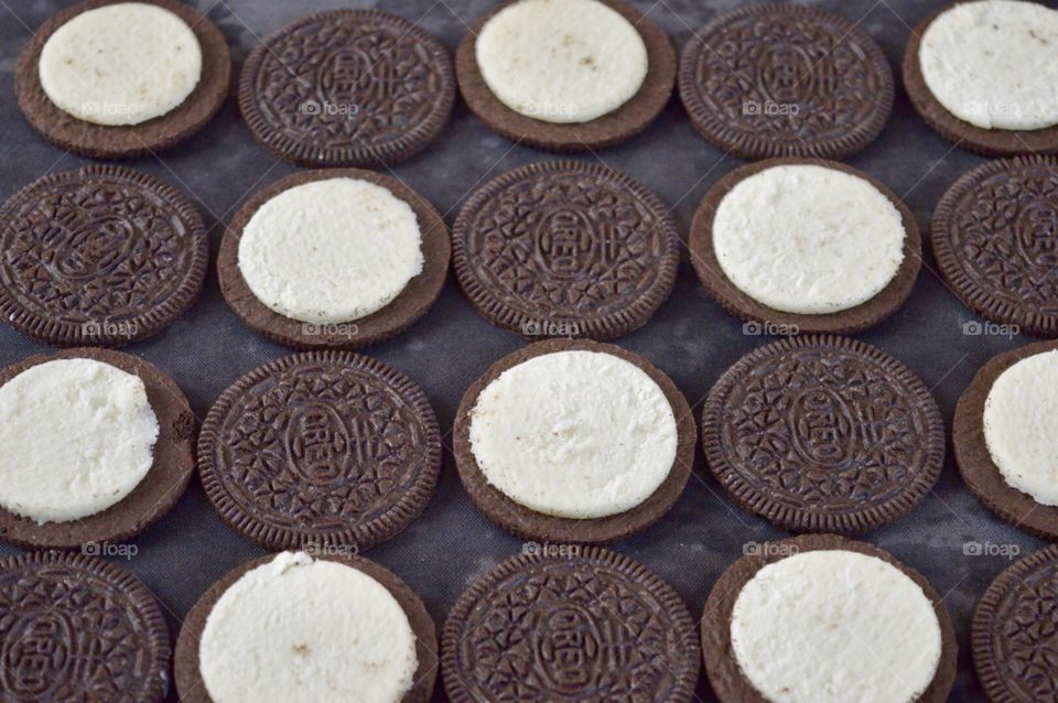 Contrasting Oreo cookies on a black background 