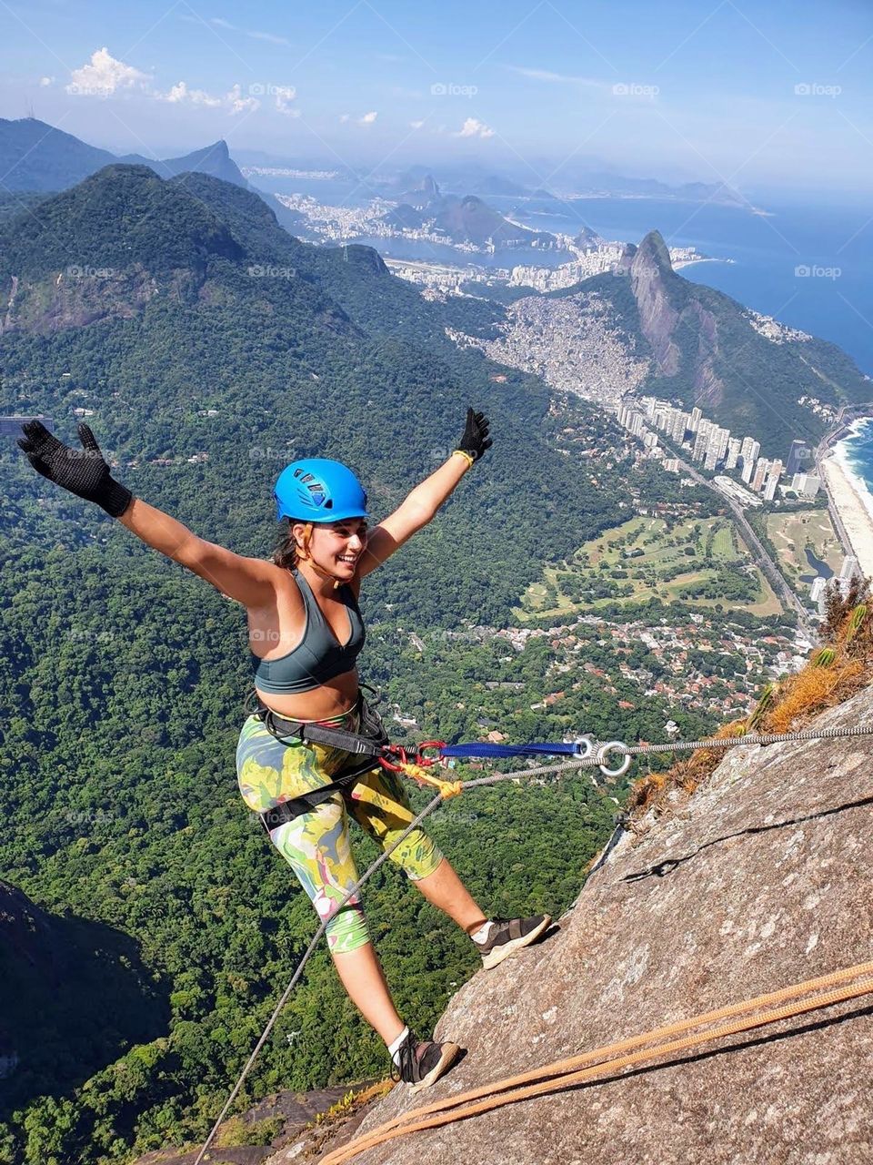 Girl glimpsing the city of Rio de Janeiro over Pedra da Gávea