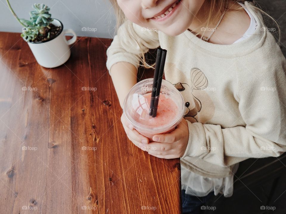 Happy kid with smoothie 