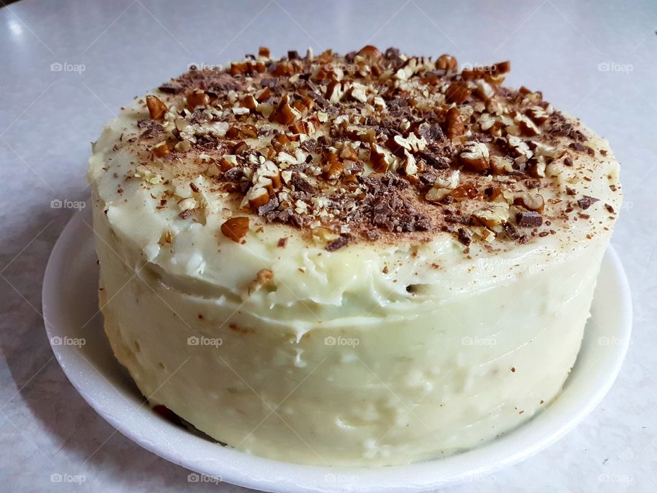Cheese cake with nuts sprinkled over it