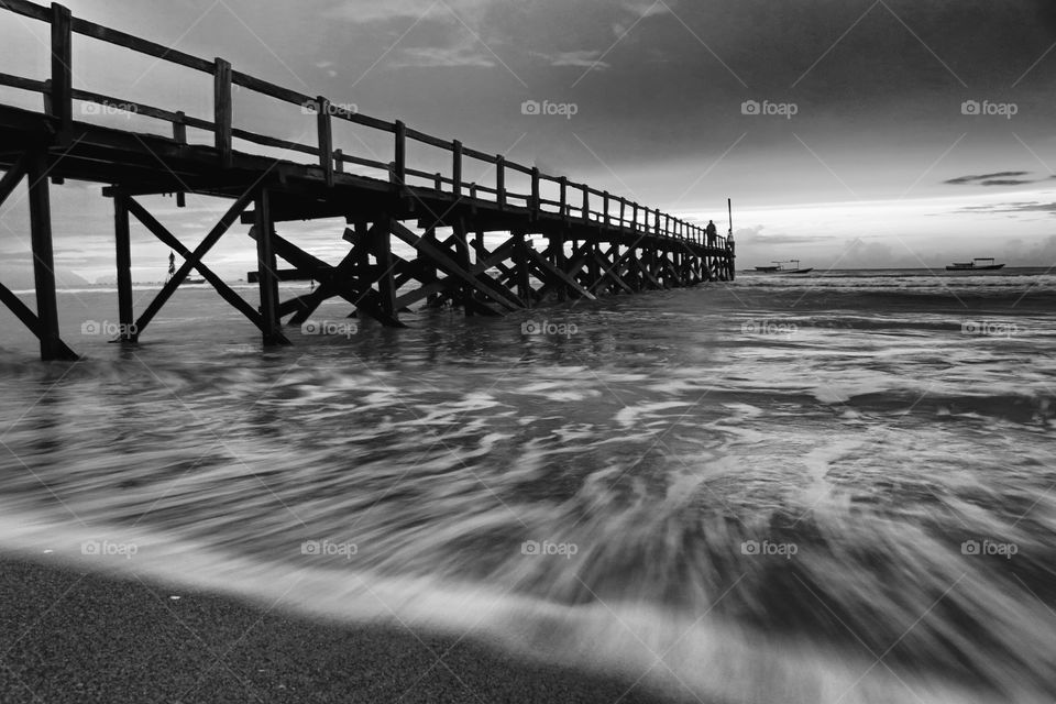 Sunrise in B&W, pier at Angsana beach, South Kalimantan, Indonesia.