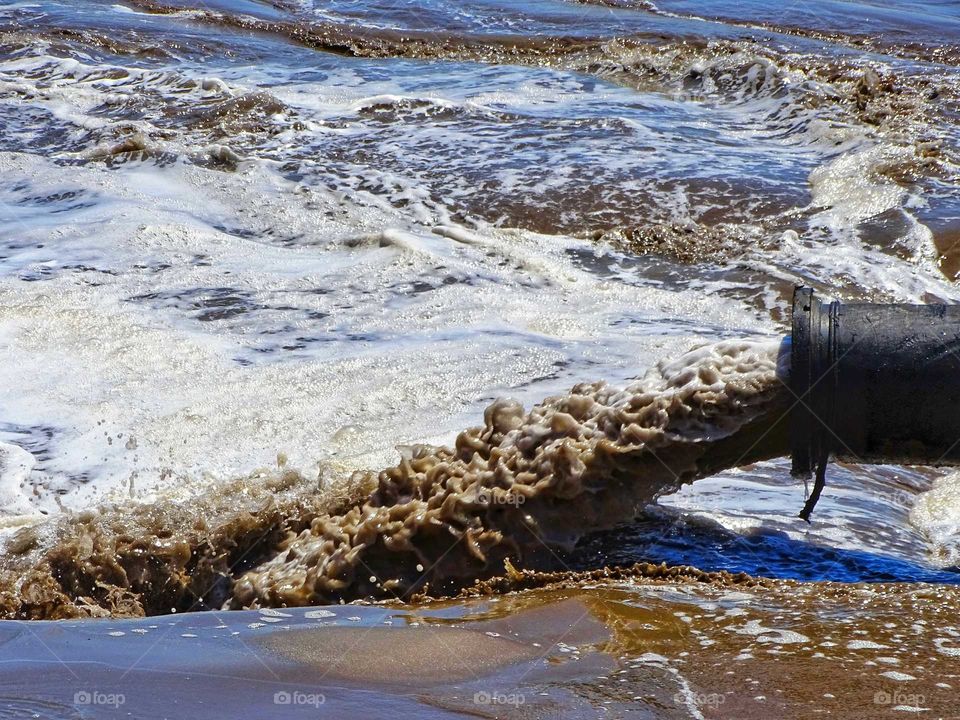 Pumping water and sand on the beach