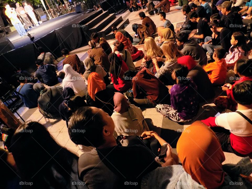 Watching an outdoor show at a folk party event at night