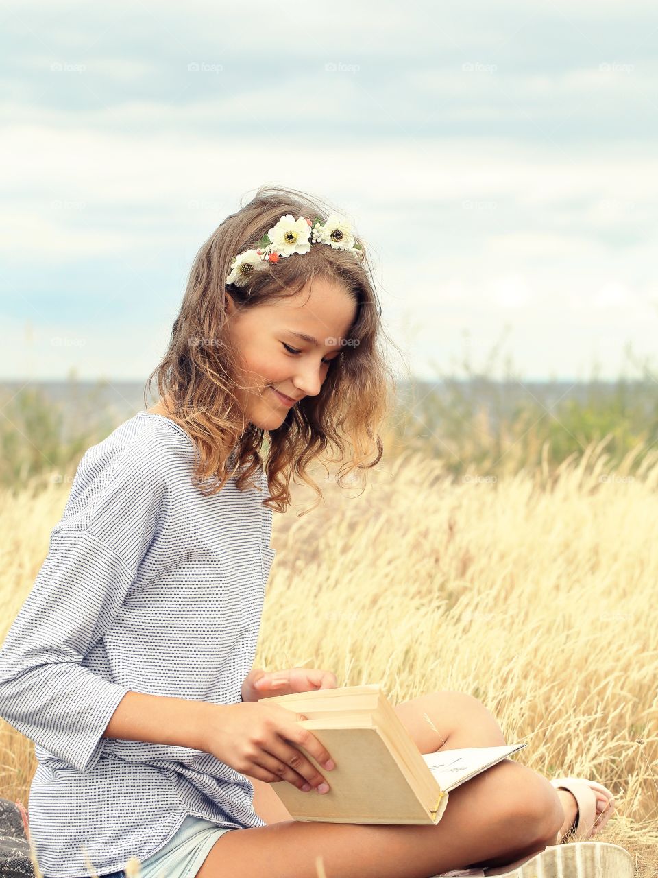 Beautiful smiling girl reading a book 
