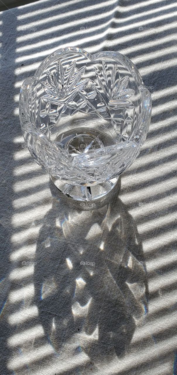 Monochromatic, B&W, shadows, reflections, sunlight through window and crystal candle holder. Waterford Crystal.
