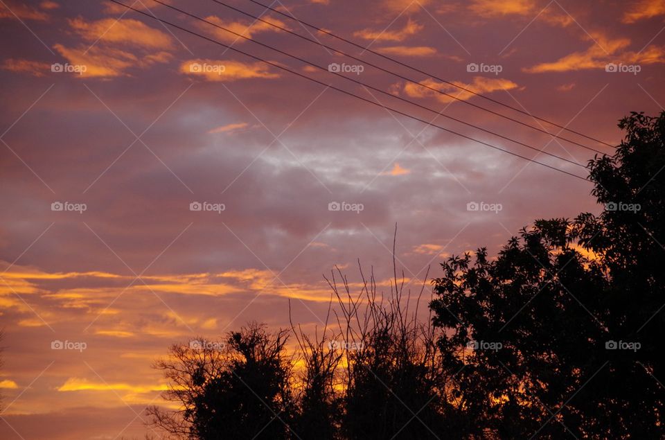 Sunset sky clouds red orange grey sun 