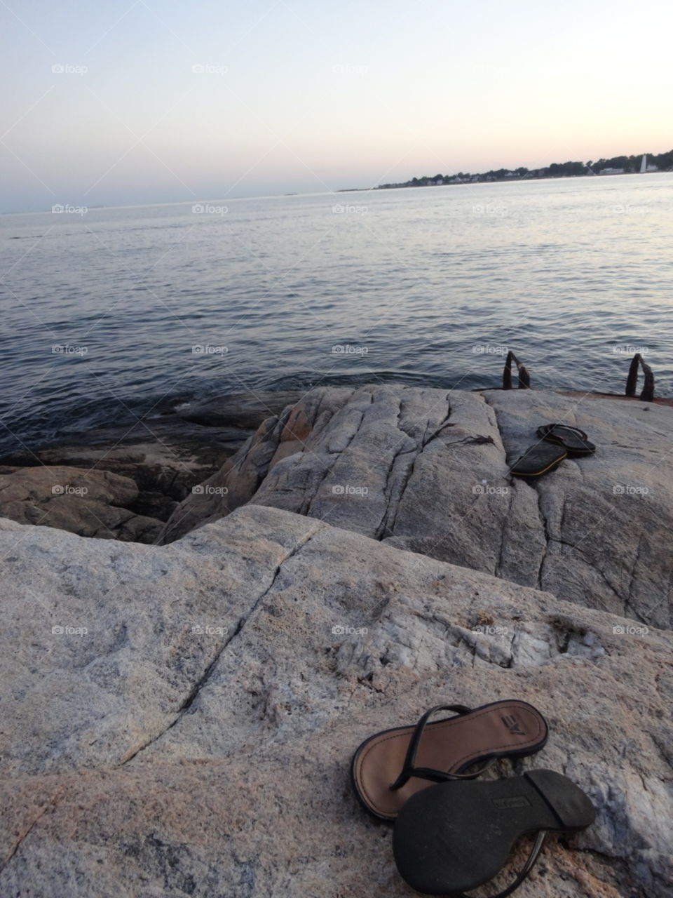 A couple on an adventure on the coast of Connecticut leaving their flip flops behind.
