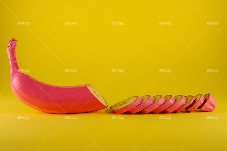pink banana. half sliced. minimal food concept