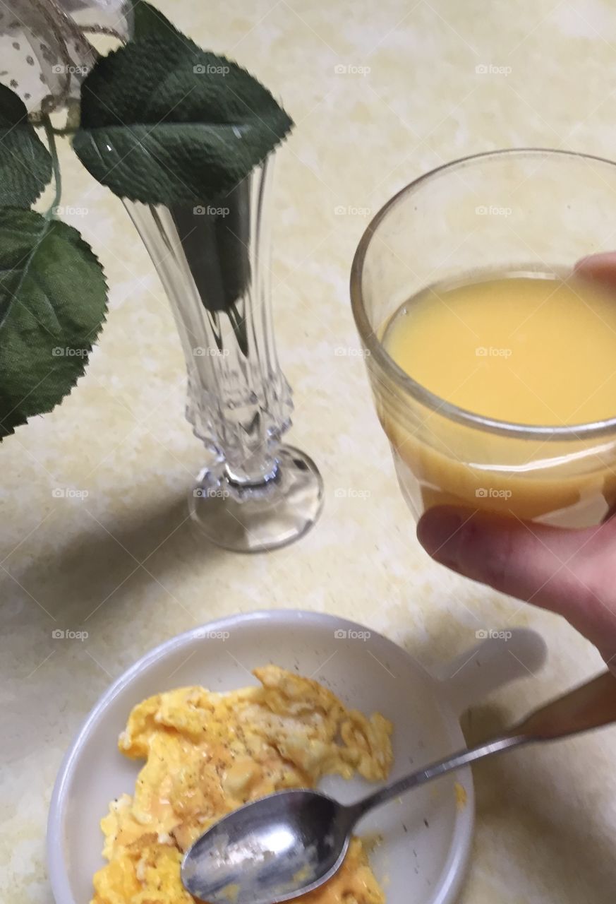 Morning ritual orange juice and scrambled eggs