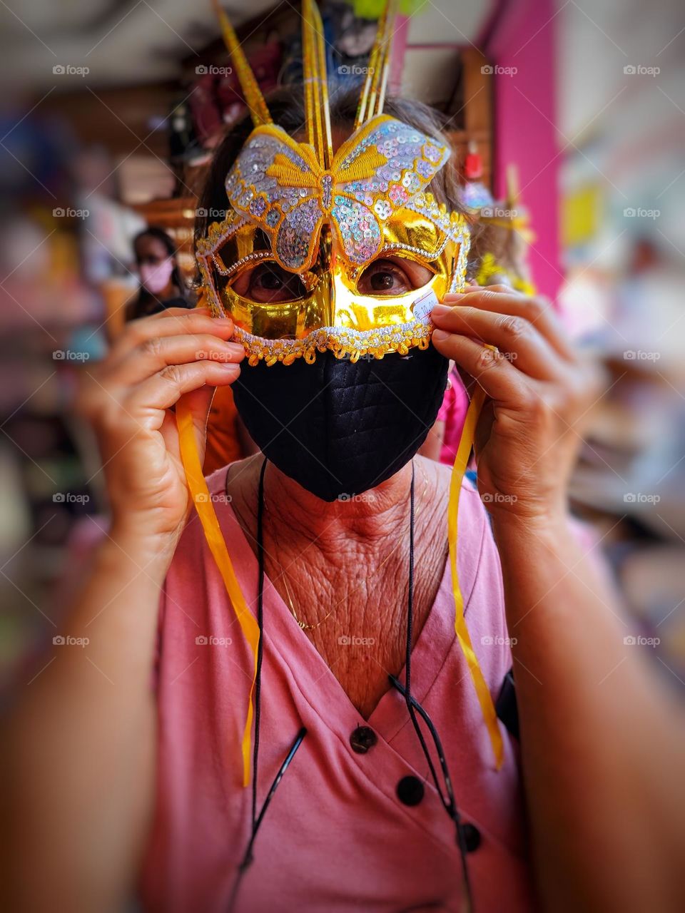 woman wearing golden mask and protection mask.