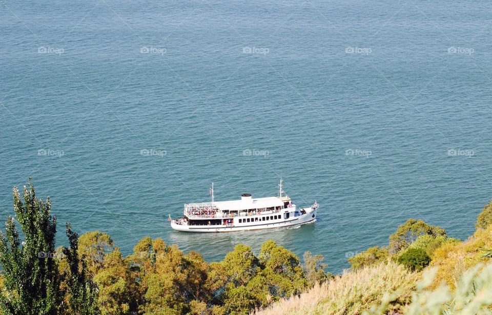 Party on a boat sailing in the ocean. People having fun and dancing in the sea 