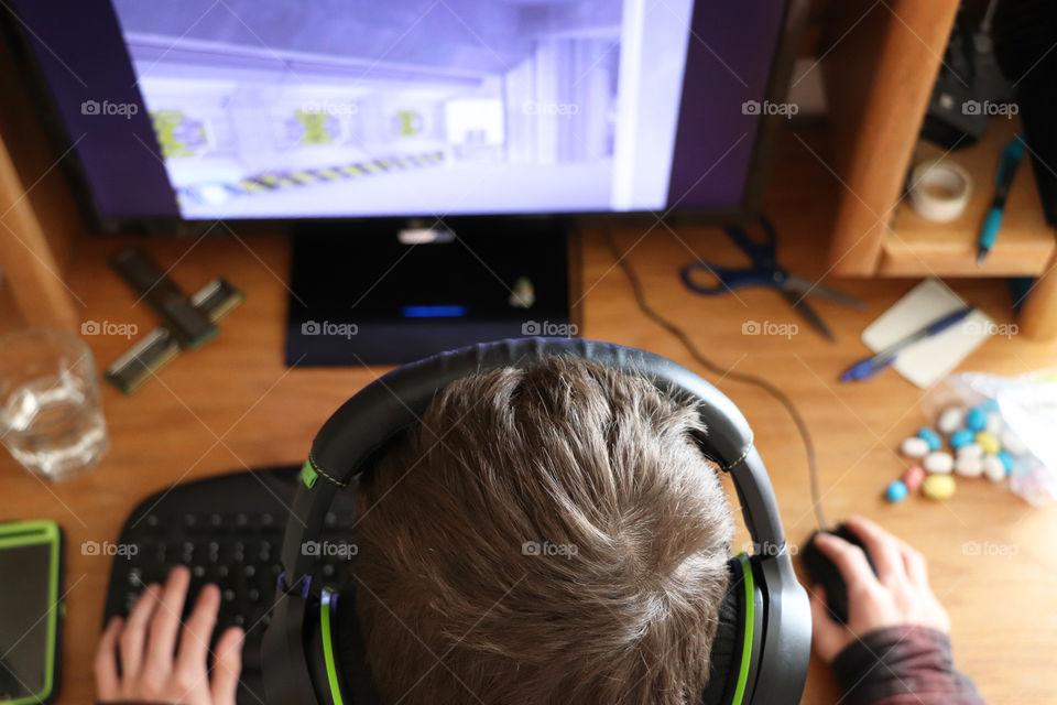 Teenager playing video games on the computer