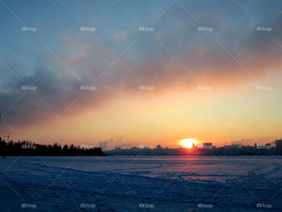 sunset in winter with cold weather in January, frost and sun