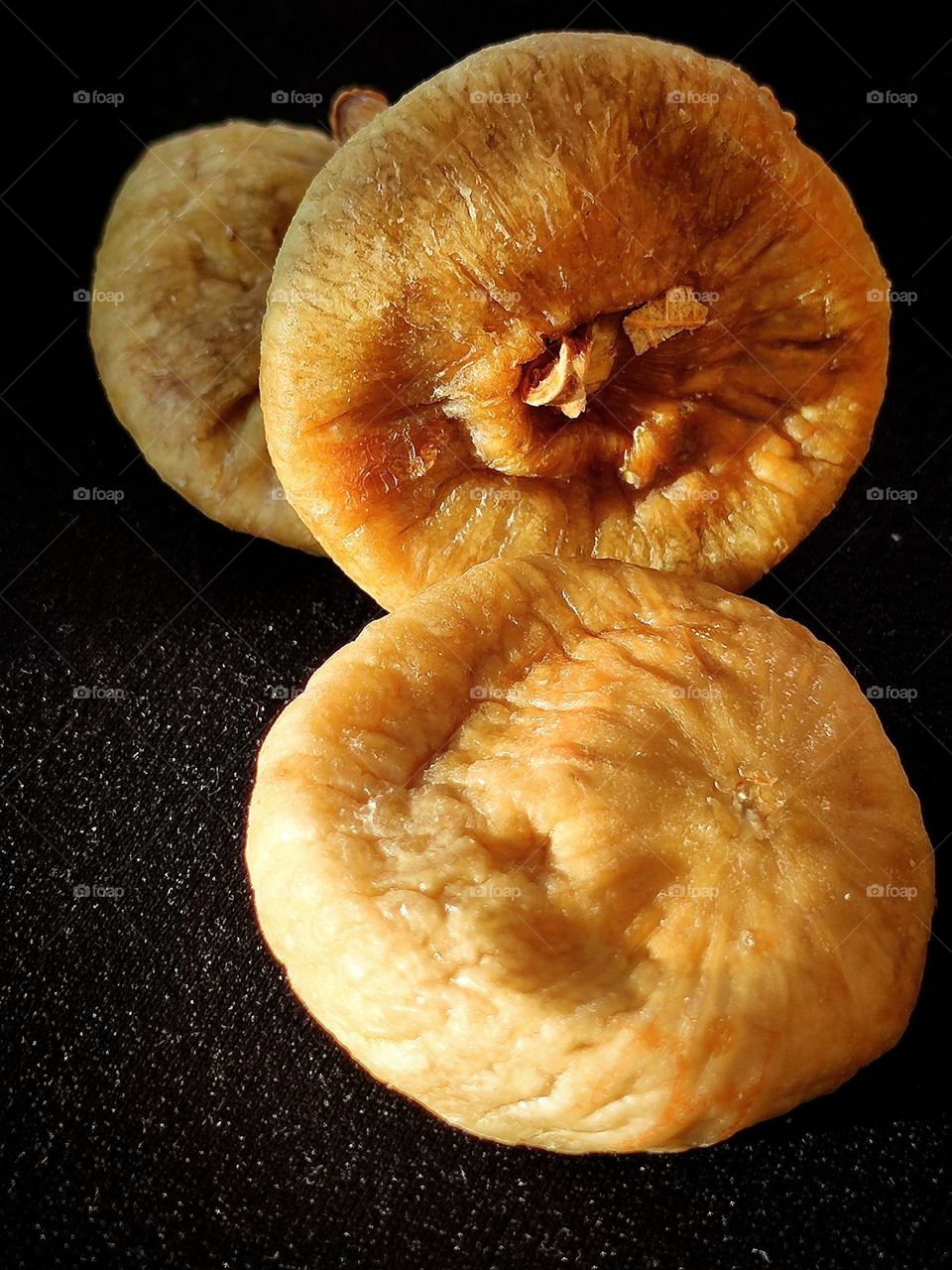 Eastern sweetness.  Dried figs glow in the sun like amber.  Contrast creates a black background