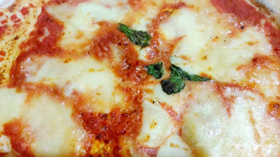 Original pizza margherita cooked in a wooden oven
