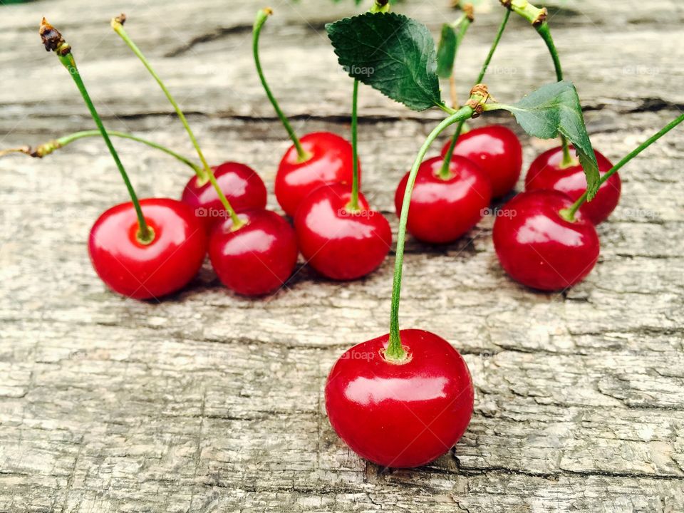 Overhead view of cherries on wooden table