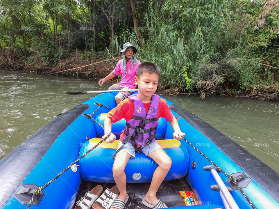 Tourists on the inflatable boat floating on the water in the river The flow of Kaeng Krachan Dam at Phetchaburi in Thailand. June 10, 2019