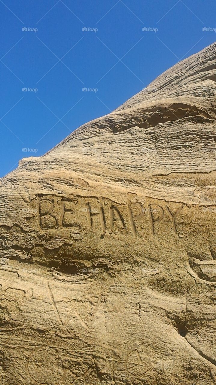 Be Happy. Walking along the beach and found the rock was soft enough to carve in to. Decided to spread some positive words.