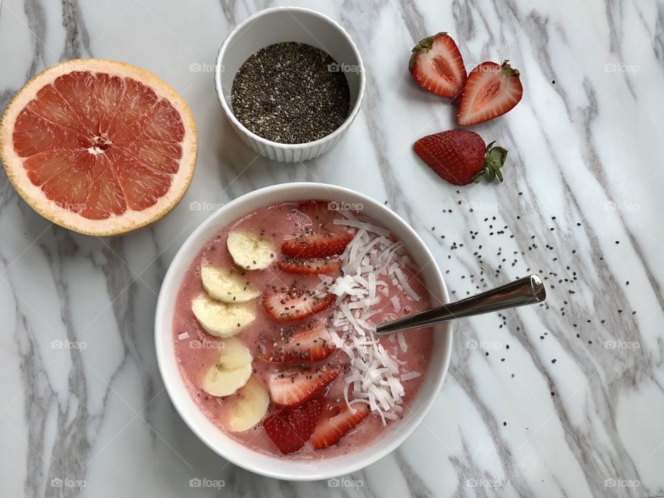 Strawberry smoothie bowl on flooring