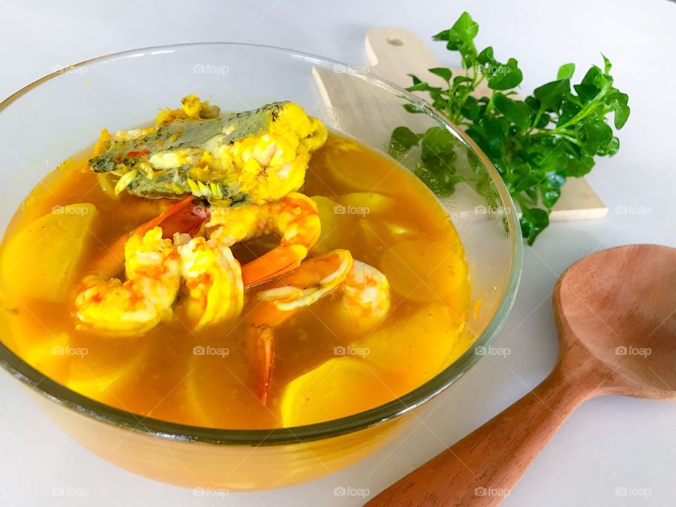 Shrimp and fish with sliced white radish in yellow sour and spicy soup from southern Thai cuisine
