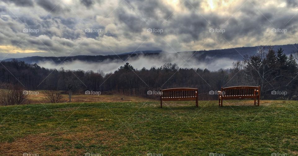 Seats over the foggy valley 