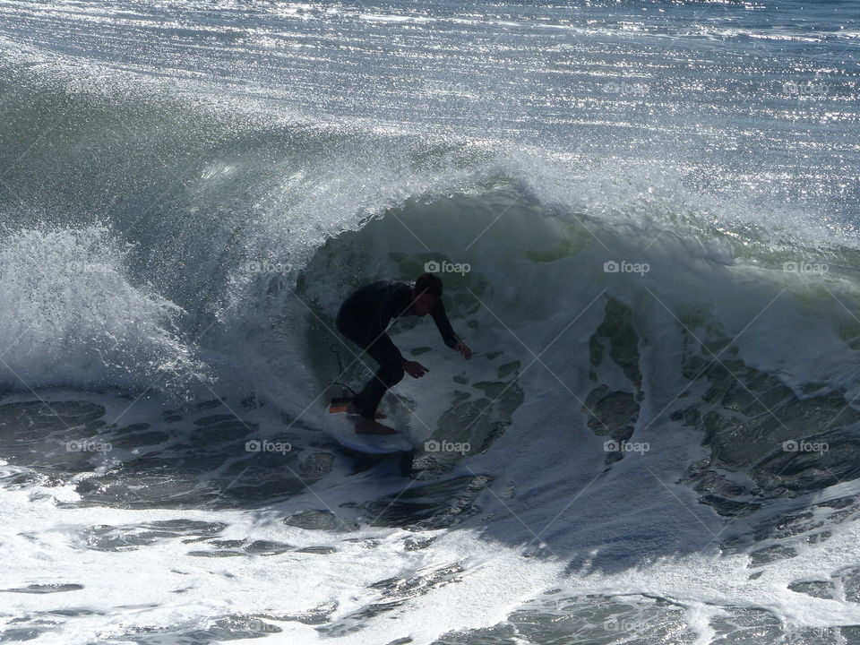 Surfer silhouette shooting the curl