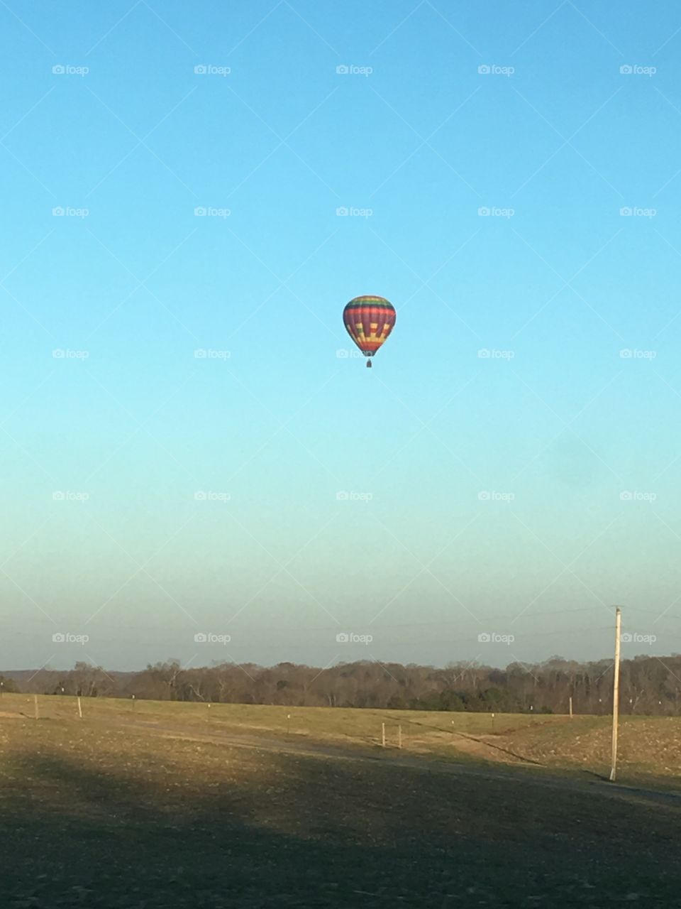 Hot air balloon flying at dusk in rural North Carolina.