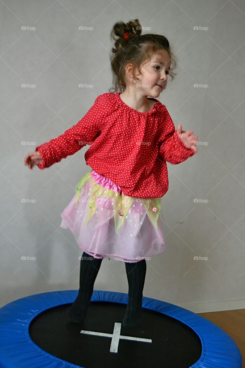 Small girl posing on trampoline