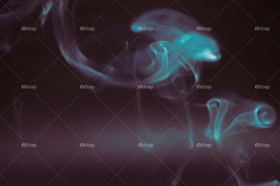 Smoke scented candles on a black background