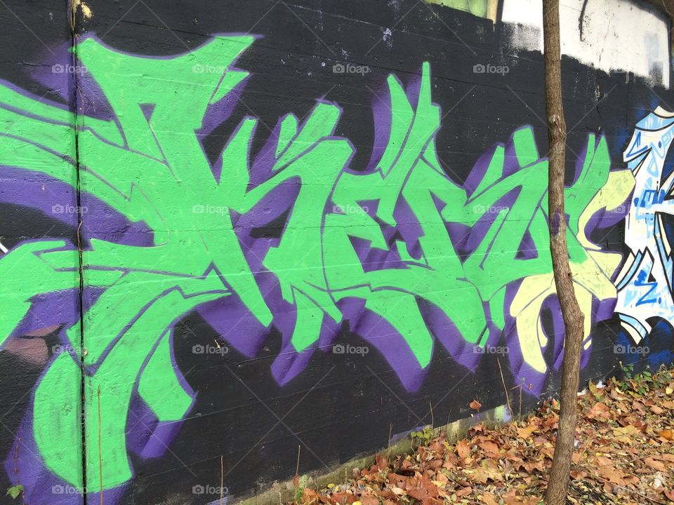 Large green graffiti piece on wall 