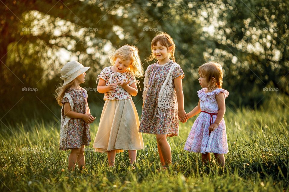 Little girls friends boho outdoor portrait at sunset