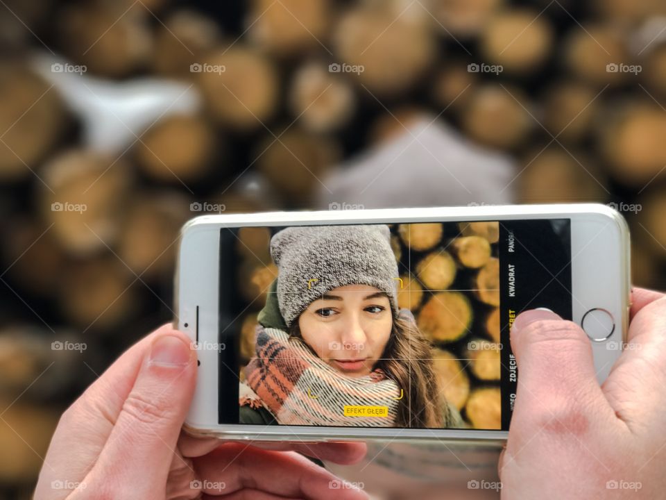 A person taking photograph of woman