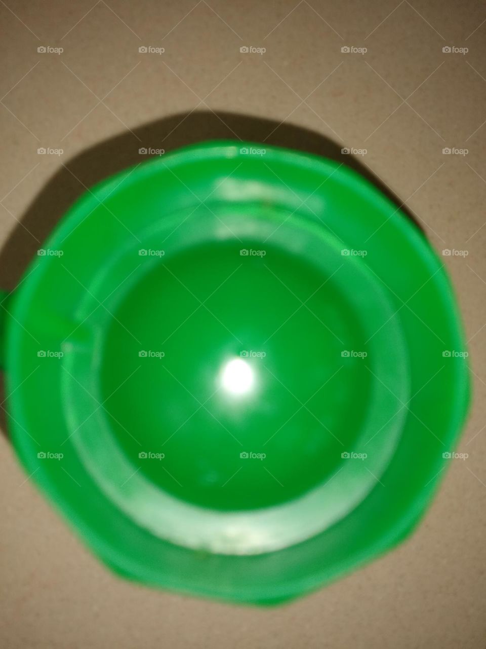 Green cup 🍵 bottom is circle shaped as well as the light in the middle of it ☺️