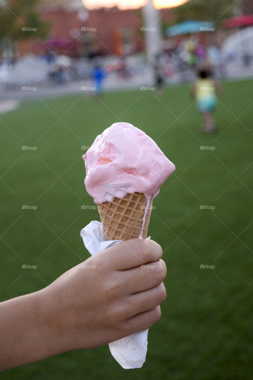 Hand holding ice cream cone 