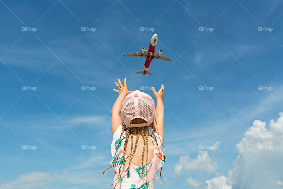 Girl and airplane in sky