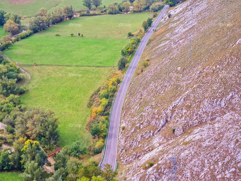 mountain road surrounded by greenery photographed from above